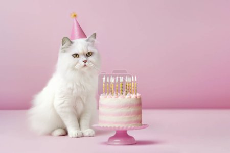 Fluffy white cat wearing a party hat celebrating with a birthday cake with gold birthday candles