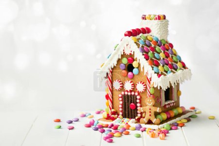 Photo for Gingerbread house decorated with colorful candies against a white background - Royalty Free Image
