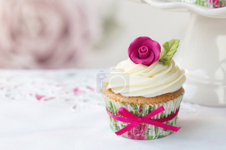 Photo for Cupcake decorated with a pink sugar rose - Royalty Free Image