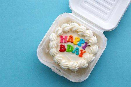 Téléchargez les photos : Mini gâteau d'anniversaire avec message joyeux anniversaire coloré dans une boîte à lunch en carton - en image libre de droit