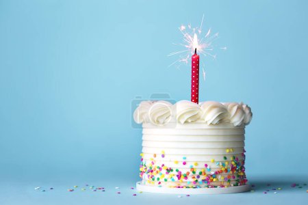 Photo for Birthday cake with colorful sprinkles and one red birthday candle against a plain blue background - Royalty Free Image