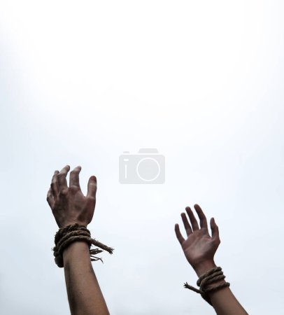 Photo for Close up raise finger jail abuse right ask god religion faith belief help hope white text space. Closeup pain string cord knot bind wrist young restrain stress addict release convict religious victory - Royalty Free Image