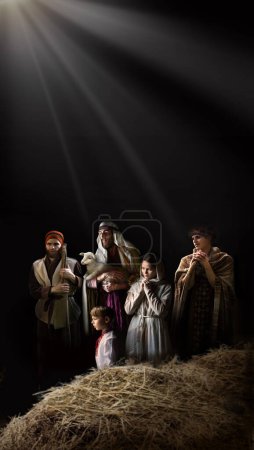 Photo for Cheer smile jewish guy come Lord boy kid crib life noel eve card dark black text space Old retro jew stable straw barn cave hand hold bring bless pray hope lamb scene new gospel church love star light - Royalty Free Image