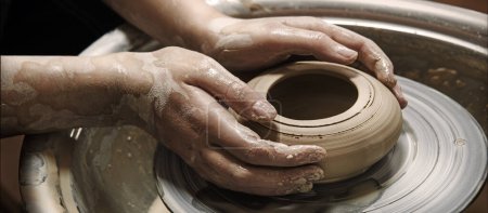 Photo for Closeup rural bible god male artisan worker dirty arm touch tool teach ancient retro old earthen culture water mug pitcher vessel ware. Rustic antique wet hobby table girl learn make pan dish design - Royalty Free Image