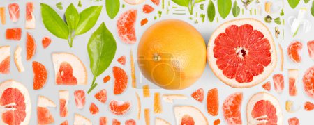 Photo for Grapefruit fruit piece, slice and leaf collection. Flat lay, seamless abstract on gray background. - Royalty Free Image