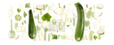 Photo for Abstract background made of Zucchini vegetable pieces, slices and leaves isolated on white. - Royalty Free Image
