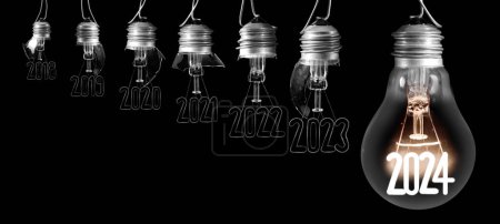 Photo for Horizontal group of shining light bulb with fiber in a shape of New Year 2024 and broken light bulbs with years passed isolated on black background. - Royalty Free Image