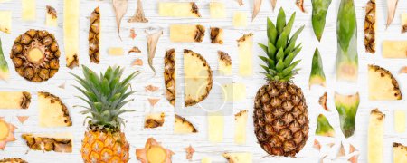 Photo for Pineapple fruit piece, slice and leaf collection. Flat lay, seamless abstract on wooden background. - Royalty Free Image