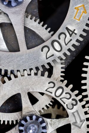 Photo for Photo of tooth wheel mechanism with numbers 2024 and 2023 and arrows imprinted on metal surface. New Year concept. - Royalty Free Image