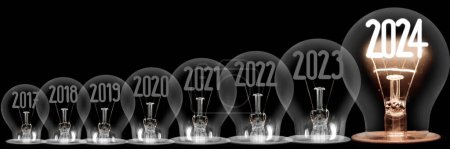 Photo for Horizontal group of shining light bulb with fiber in a shape of New Year 2024 and dimmed light bulbs with years passed isolated on black background. - Royalty Free Image
