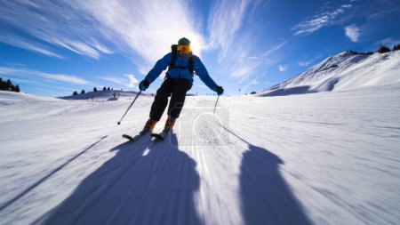 professional skier skiing on slopes in the Swiss alps towards the camera