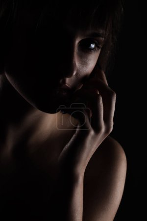 Foto de Retrato de belleza iluminado lado oscuro de una dama con el pelo corto - Imagen libre de derechos