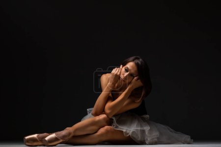Photo for Ballerina with a tutu posing on the floor - Royalty Free Image