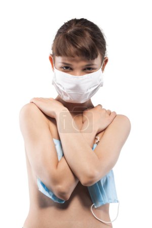 Portrait of a young woman wearing a medical face mask covering her mouth and nose, exuding a subtle expression of concern and thoughtfulness.