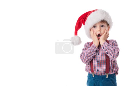 Good baby boy with surprised expression, wearing in tie, suspender and Santa Claus cloth, Christmas concept