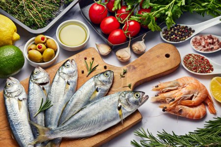 Photo for Fresh Fish Food background. Different seafood, shrimps and red caviar. Fish for cooking with herbs, vegetables and spices isolated on white background. Raw Meats Panorama banner. - Royalty Free Image
