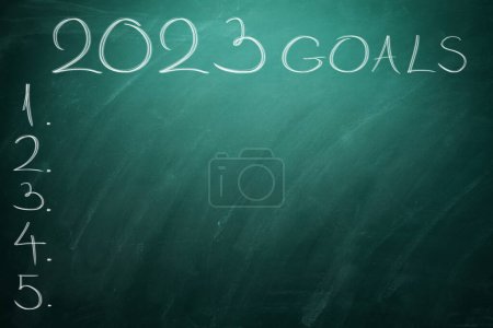 Photo for Happy new year 2023 Goals and expectations, text on black board. Chalk Board with to do list for upcoming time. - Royalty Free Image