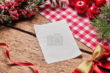 Photo for Merry Christmas text card or letter on wooden desk with holiday new year decoration. - Royalty Free Image