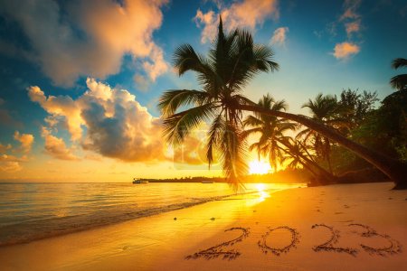 Photo for Happy New Year 2023 text on island beach sand. Sea sunrise. Punta Cana, Dominican Republic - Royalty Free Image