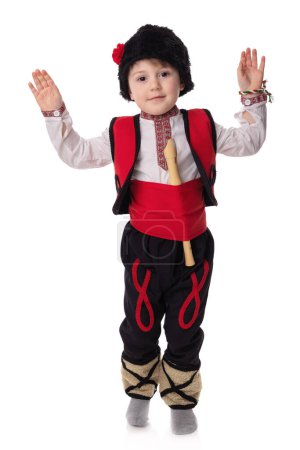Photo for Bulgarian boy musician with flute in traditional folklore costume with martenitsa symbol of spring, Baba Marta and Easter holiday, portrait on white background,martisor - Royalty Free Image