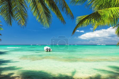 Title: Beautiful caribbean sea and boat on the ocean shore, panoramic view from the island beach