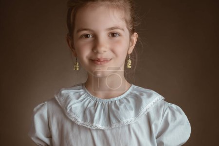 Photo for Beautiful clever pupil, little girl student, education in school, pupil, studio portrait on brown background - Royalty Free Image