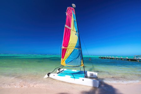 Photo for Color catamaran sailboat, windsurf, kayak, and parasailing summer water activities on tropical island beach and caribbean sea shore - Royalty Free Image