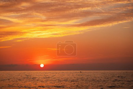 Téléchargez les photos : Beau paysage nuageux sur la surface de l'eau de mer, coup de soleil levant - en image libre de droit