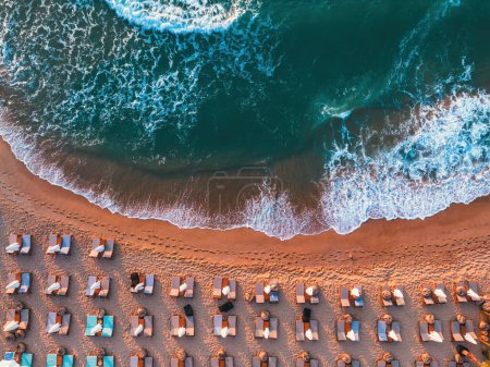 Photo for Aerial top view on the beach. Umbrellas, sand and sea waves - Royalty Free Image