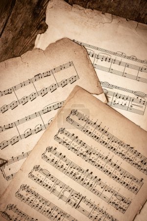 Photo for Old Music Sheets On Wooden Background - Royalty Free Image