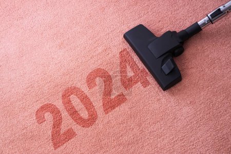 Photo for 2024 New year home cleaning with vacuum cleaner and copy space for a text - Royalty Free Image