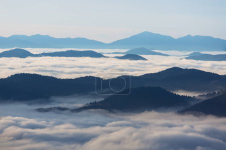 Photo for Sunrise over the mountain peaks with fog and clouds - Royalty Free Image