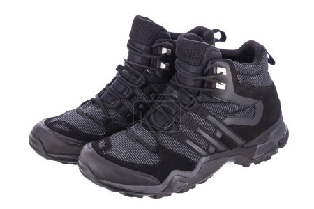 Foto de Zapatos impermeables botas de invierno al aire libre para senderismo o trekking aislados sobre fondo blanco - Imagen libre de derechos