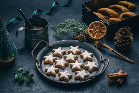 Photo for Christmas gingerbread Italian cookies cuccidati, cuccidati biscuits on seasonal holiday background with old rustic cup, cinnamon and orang - Royalty Free Image