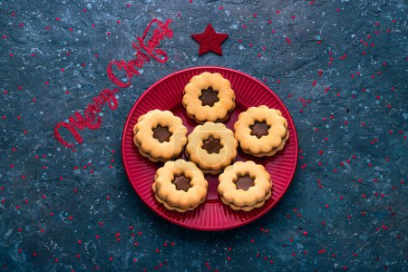Photo for Traditional Christmas Linzer cookies Austrian or German biscuits with shortcrust pastry and jam filling seasonal holiday background - Royalty Free Image