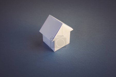 Photo for White paper house origami isolated on a blank grey background. - Royalty Free Image