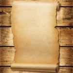 Old mediaeval paper sheet. Parchment scroll isolated on a wood board background