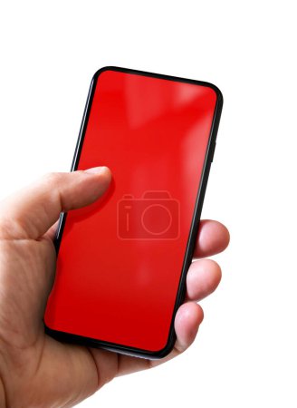 Foto de Hand holding a smartphone with blank red screen. Isolated on white background. - Imagen libre de derechos