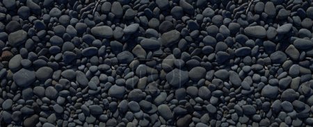 Téléchargez les photos : Des cailloux noirs sur une plage. texture de fond. Papier peint bannière - en image libre de droit