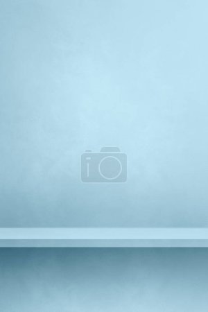 Photo for Empty shelf on a light blue concrete wall. Background template scene. Vertical mockup - Royalty Free Image