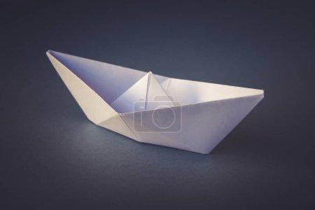 Photo for White paper boat origami isolated on a blank grey background. - Royalty Free Image