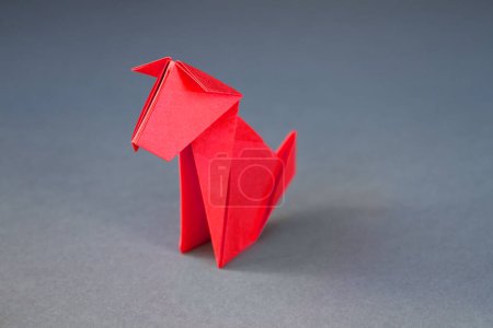 Photo for Red paper dog origami isolated on a blank grey background. - Royalty Free Image
