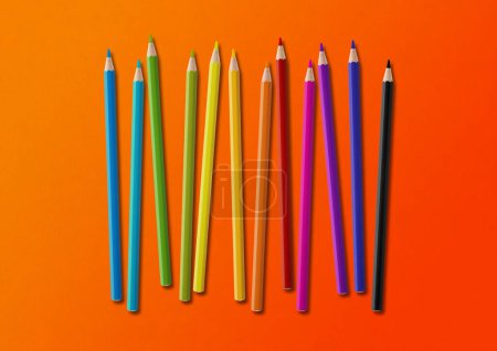 Photo for Wooden colored pencil set isolated on orange. Horizontal background. - Royalty Free Image