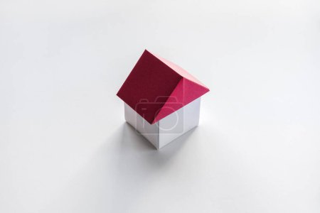Téléchargez les photos : Origami maison en papier blanc et rouge isolé sur un fond blanc. - en image libre de droit