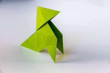 Foto de Green paper hen origami isolated on a blank white background. Cocotte en papier - Imagen libre de derechos