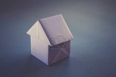 Photo for White paper house origami isolated on a blank grey background. - Royalty Free Image