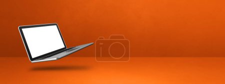 Photo for Blank computer laptop floating over an orange background. 3D isolated illustration. Horizontal banner template - Royalty Free Image