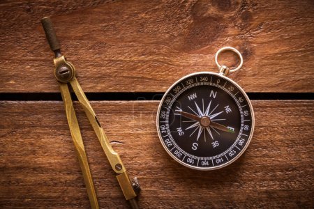 Photo for Vintage drawing and navigational Compass on a rustic wooden board - Royalty Free Image
