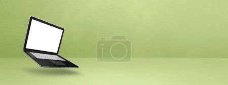 Photo for Blank computer laptop floating over a green background. 3D isolated illustration. Horizontal banner template - Royalty Free Image