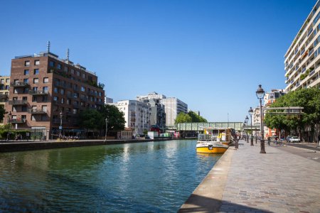 Photo for Paris - France - June 05, 2023 : Ourcq canal and houseboat view from the banks in summer - Royalty Free Image
